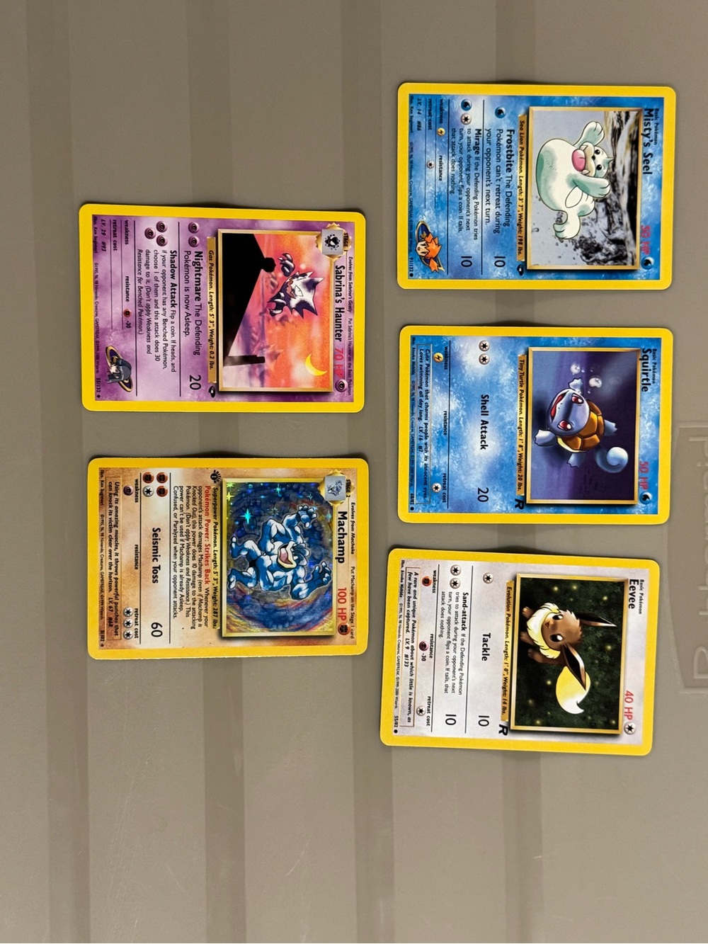 A collection of early 1999-2000 Pokémon TCG cards.  Set of 5 one holographic